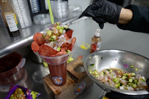 Patsy Aguilar prepares a dish on her Pata Salada Ceviches food truck at La Plaza Colorado in Aurora, Colorado on Friday, March 7, 2025. (Photo by Hyoung Chang/The Denver Post)